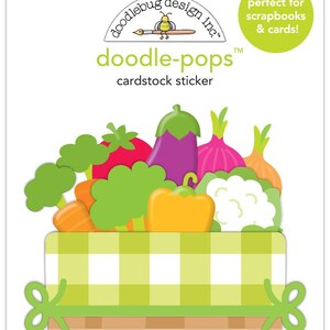 May include: A sticker sheet with a basket of colorful vegetables. The vegetables include a red strawberry, a purple eggplant, a pink onion, a yellow bell pepper, a green broccoli, and a white cauliflower. The basket is brown with a green and white checkered pattern.