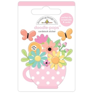 May include: A cardstock sticker sheet featuring a floral arrangement in a pink polka-dotted teacup. The arrangement includes butterflies, daisies, and other colorful flowers. The text "doodle-pops" and "cardstock sticker" are visible.