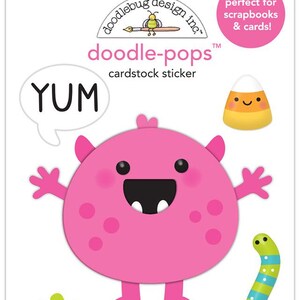 May include: A sheet of Doodlebug Design Inc. doodle-pops cardstock stickers. The stickers include a pink monster, a candy corn, a pumpkin, a candy, and a green and blue worm. The word "YUM" is in a speech bubble.