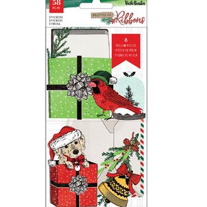 May include: A pack of Vicki Boutin "Wrapped in Ribbons" ephemera, containing 58 pieces, including vellum pieces. The images feature a red cardinal, a puppy in a Santa hat, and Christmas gift boxes.