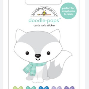 May include: A cardstock sticker sheet featuring a cartoon fox with a blue and green scarf. The fox is gray and white with black eyes and a black nose. Below the fox are five heart-shaped stickers in shades of green, blue, and purple. The packaging says "doodle-pops" and "cardstock sticker".