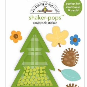 May include: A green and brown shaker-pops cardstock sticker featuring a green plaid Christmas tree with a clear window filled with yellow glitter. The sticker sheet also includes a brown and tan pine cone, a yellow leaf, a blue flower, a light blue leaf, and an orange flower.