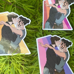 May include: Four stickers featuring an illustration of two people embracing and kissing. The artwork depicts two individuals with dark hair, one in a black jacket and the other in a gray shirt. The stickers have a white border and are set against a green background.
