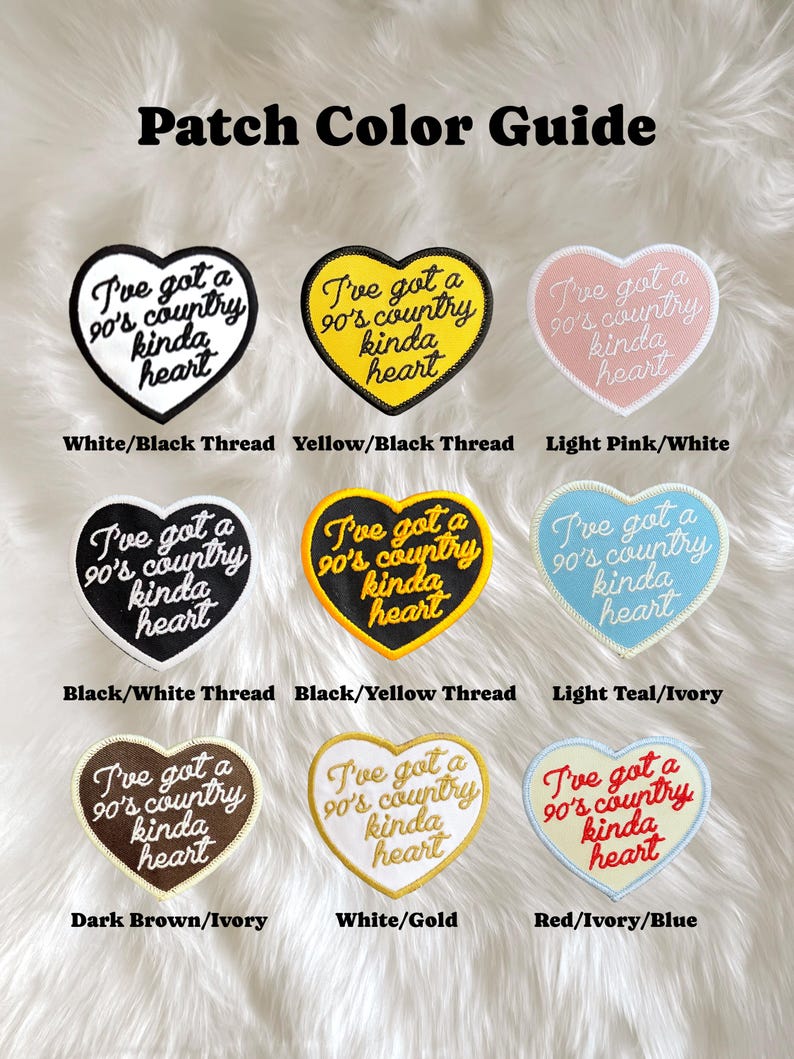 May include: A colour guide for iron-on patches featuring a heart-shaped design with the text "I've got a 90's country kinda heart". The patches are shown in nine different colour combinations, including white/black, yellow/black, light pink/white, black/white, black/yellow, light teal/ivory, dark brown/ivory, white/gold, and red/ivory/blue.