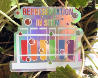 May include: A holographic sticker with the text "Representation in STEM" and a rainbow-colored illustration of test tubes.