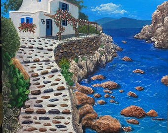 May include: A white cottage with a blue door and a stone path leading down to a blue body of water. The water is surrounded by rocks and there are mountains in the distance.