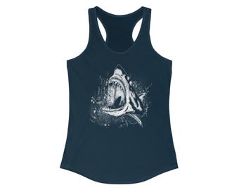 May include: A navy blue tank top with a white graphic of a shark with its mouth open. The shark is surrounded by a white splatter pattern.