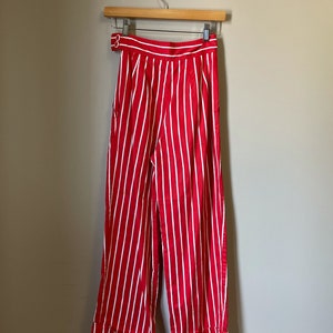 May include: Red and white striped wide-leg pants with a button closure at the waist.