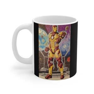 May include: White ceramic mug with a black background featuring a yellow and red Iron Man illustration standing in a space scene with planets and stars.