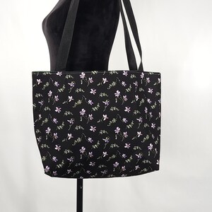 Delicate flowers on black tote bag
