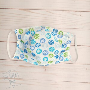 Cartoon snowflakes on white reversible two layer cotton fabric face mask / Face mask cover