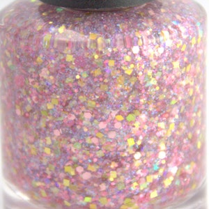 May include: A clear glass bottle of pink nail polish with a variety of iridescent glitter. The glitter is in different shapes and sizes, including small circles, squares, and hexagons.