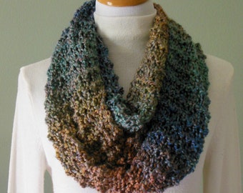 Hand Knit Infinity Fashion Scarf in varying shades of blue, teal, clay and ocher made with Lion Brand Painted Desert