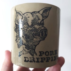 May include: A set of three ceramic mugs with a speckled, matte finish. The mugs are in shades of cream, light gray, and dark gray. Each mug has a simple, minimalist design and a rounded handle.