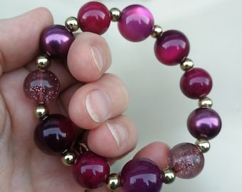 Bracelet  - pretty plastic beaded bracelet including moon glow pink beads