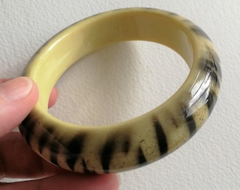 70mm in one direction 60mm the other Chunky funky yellow and black animal print  slightly oval shaped plastic bangle retro design