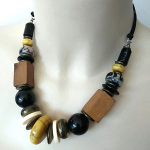 Necklace  - yellow cream and black plastic bead necklace with geometric wooden beads