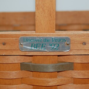 May include: A wooden basket with a metal tag that reads "Discover the Vision BEE '92".