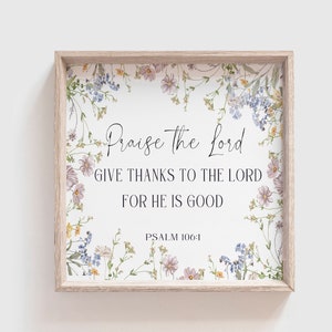 Może przedstawiać: Kwadratowa oprawiona grafika ścienna z kwiatową obwódką. Grafika zawiera tekst "Praise the Lord, GIVE THANKS TO THE LORD, FOR HE IS GOOD" i "PSALM 106:1" w eleganckim skrypcie. Rama jest w jasnym kolorze drewna.