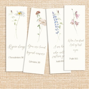 May include: Four white bookmarks with watercolor floral designs. Each bookmark features a different flower and a corresponding inspirational quote in elegant script. The quotes include: "Rejoice always," "You are loved beyond measure," "I am he who will sustain you," and "When I am afraid I put my trust in you."