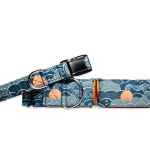 May include: A blue and white dog collar with a wave pattern and a gold moon design. The collar is made of fabric and has a metal buckle.