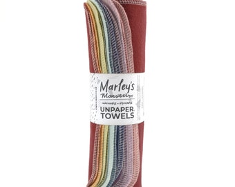 May include: A roll of colourful, reusable unpaper towels, made by Marley's Monsters. The towels are washable and reusable, and are a great alternative to paper towels. The label reads "Marley's Monsters Unpaper Towels Washable + Reusable".