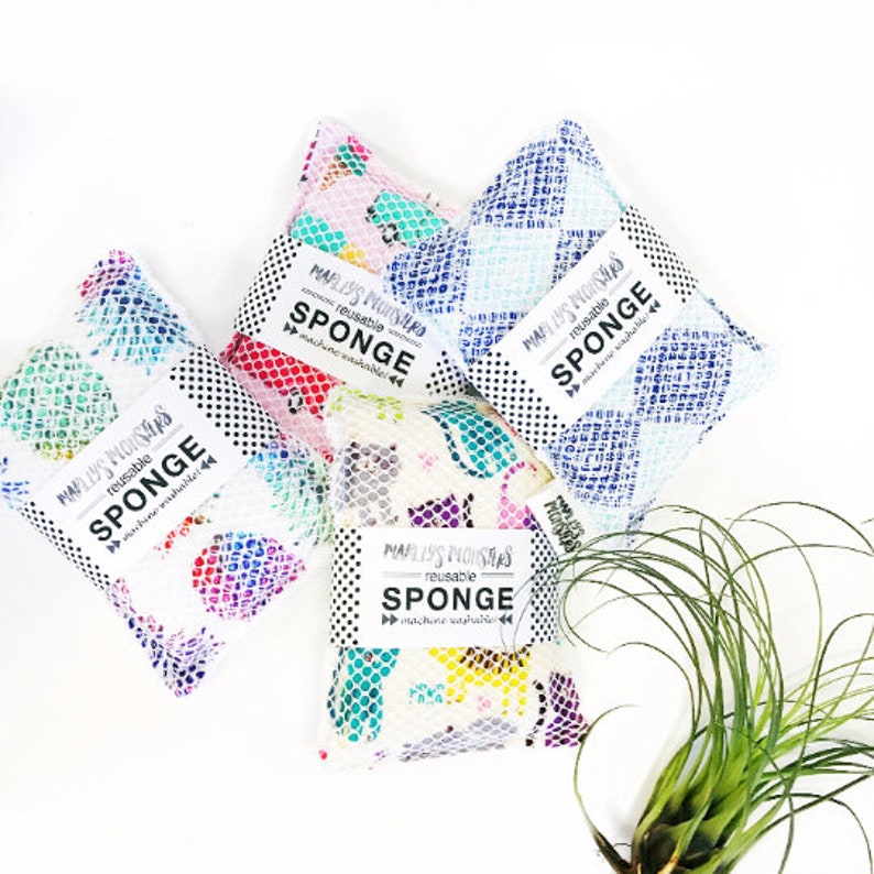 May include: Four colorful reusable sponges with a white background. Each sponge has a black and white label that reads "Maplly's Monsters reusable sponge machine washable".