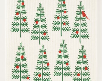 May include: A white dishcloth with a repeating pattern of green Christmas trees with red ornaments. One tree has a red cardinal perched on a branch. The text "threebluebirds" is printed in the bottom left corner.