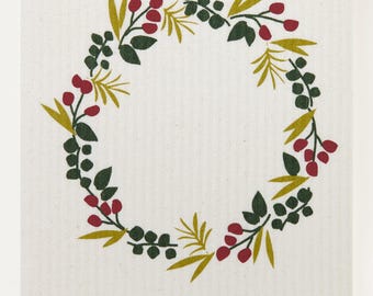 Pode incluir: Um pano de prato de algodão branco com um design de coroa verde e dourada com bagas vermelhas. O texto "threebluebirds.com" está impresso no canto inferior direito.