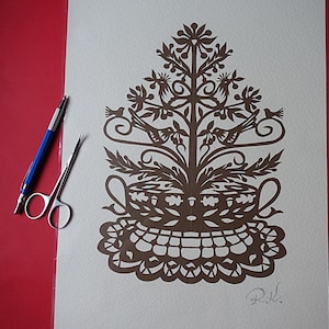 Original hand paper cut picture. Hand  paper cutting art.