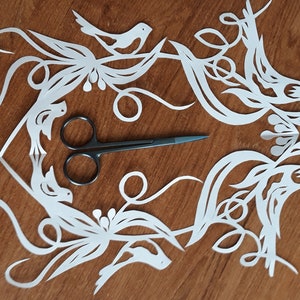 Hand cutting paper. Paper cut art birds. Original paper out cut art.
