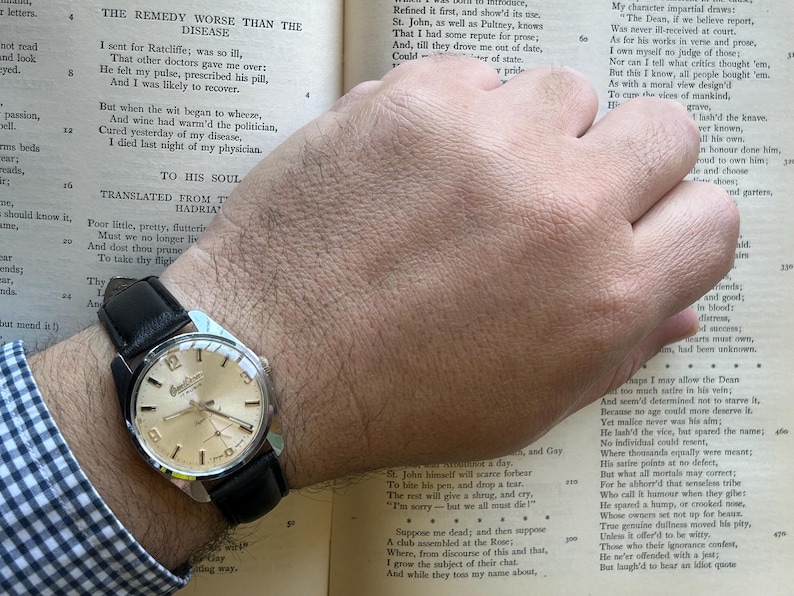 Vintage watch Omikron swiss watch with silver case and small seconds dial.  black leather band and silver crown. Running, serviced, keeps time, working.
