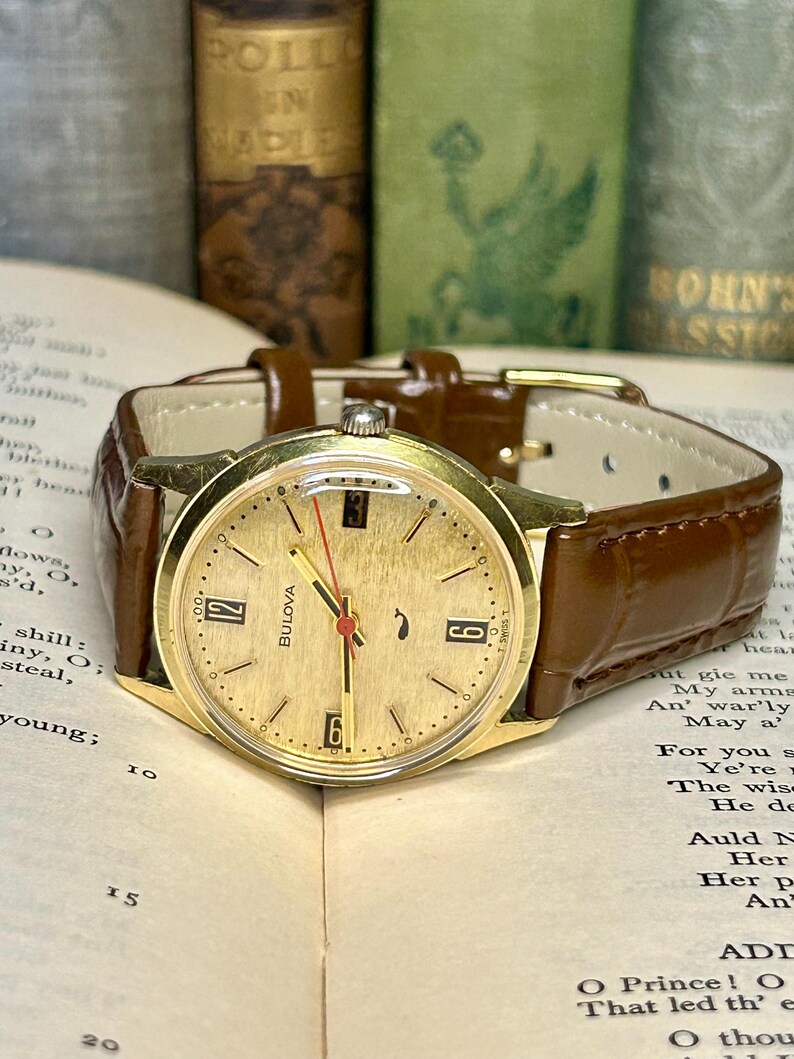 Vintage 1970 Bulova Sea King swiss watch with gold plated case and red sweep seconds dial. New brown leather band. Running, serviced, keeps time, working.