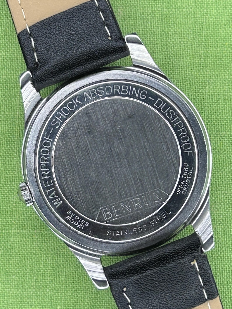 Vintage Benrus watch with black dial and stainless steel case.  Silver crown. New black leather band. Running, serviced, keeps time, working