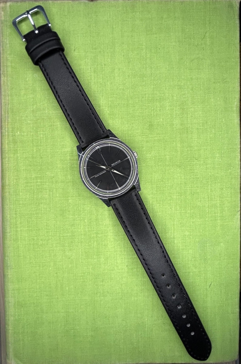 Vintage Benrus watch with black dial and stainless steel case.  Silver crown. New black leather band. Running, serviced, keeps time, working