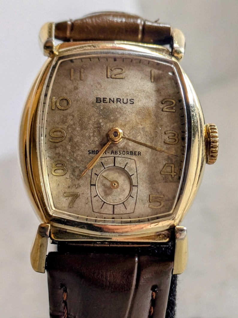 Benrus swiss tank watch with gold plated case and patina dial. New brown leather band. Running, serviced, keeps time, working