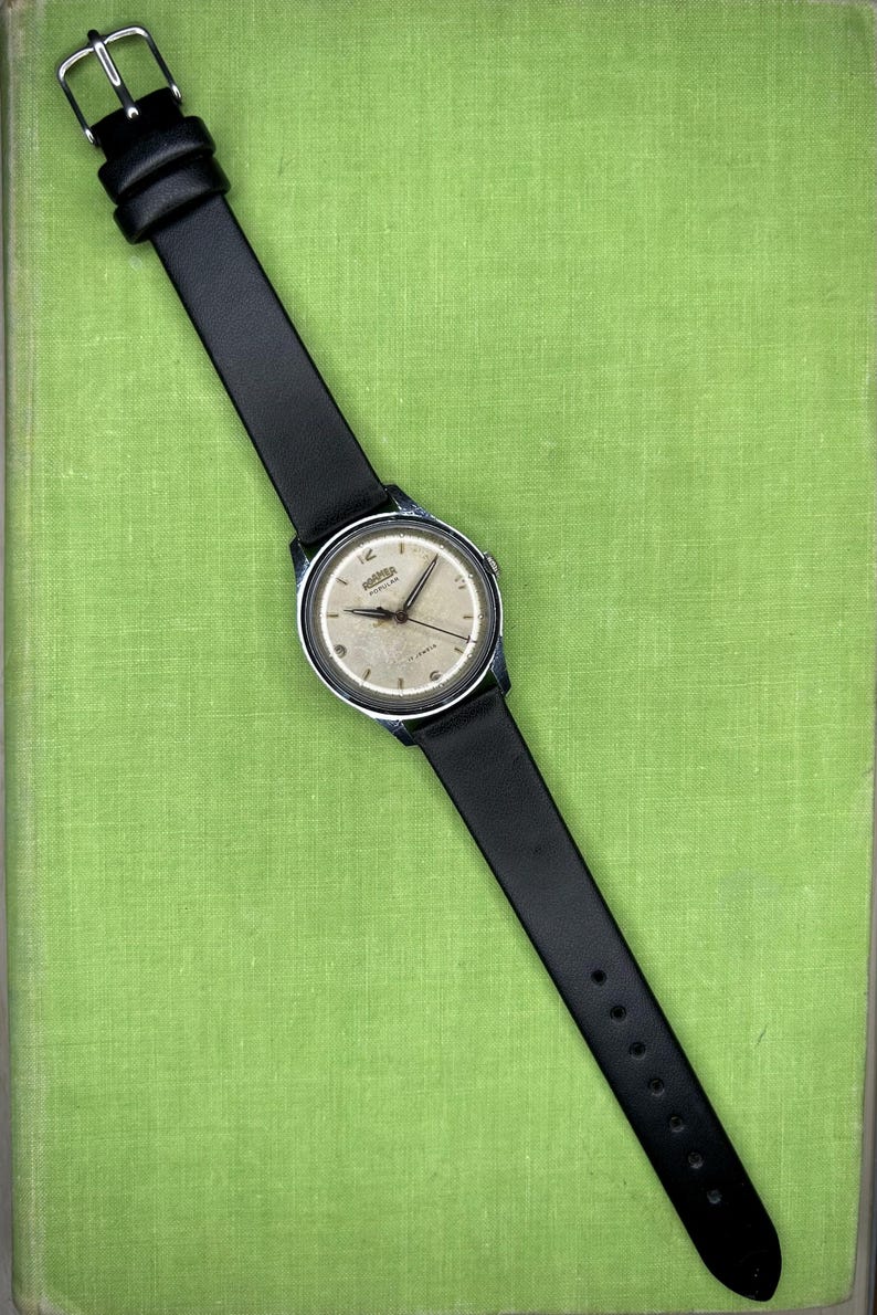 Vintage Roamer Popular watch.  black leather band.  Running, serviced working, keeping time.    Silver color case.