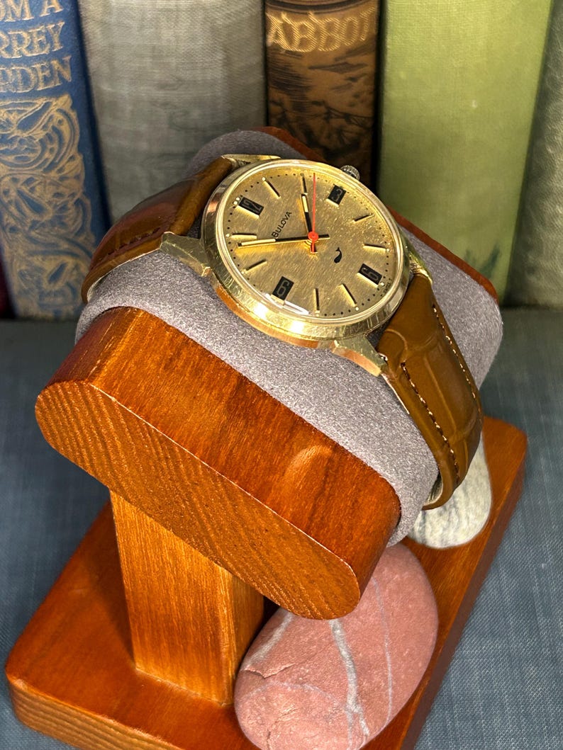 Vintage 1970 Bulova Sea King swiss watch with gold plated case and red sweep seconds dial. New brown leather band. Running, serviced, keeps time, working.