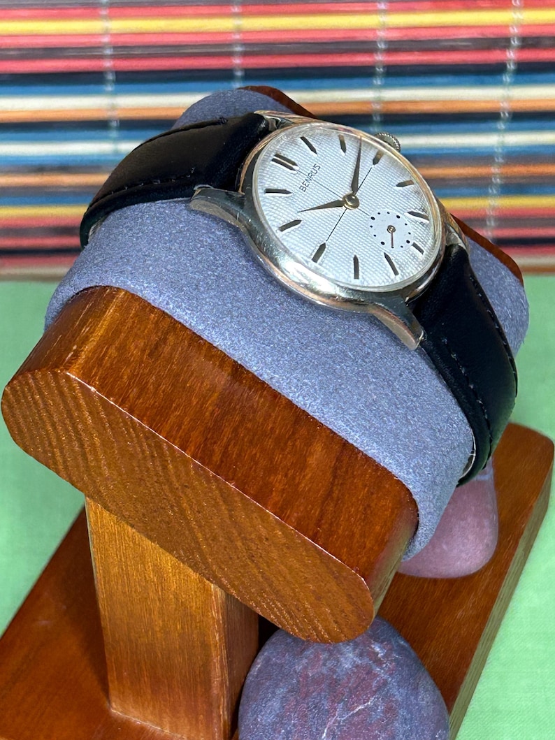 1950s Vintage Benrus crosshair watch with waffle dial and round gold plated case.  Gold crown. New black leather band. Running, serviced, keeps time, working