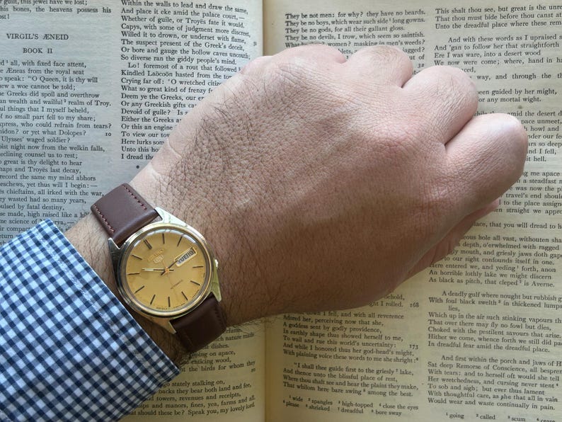 1980's era vintage Seiko automatic watch with gold dial and gold plated case.  Gold plated crown. New brown leather band. Running, serviced, keeps time, working