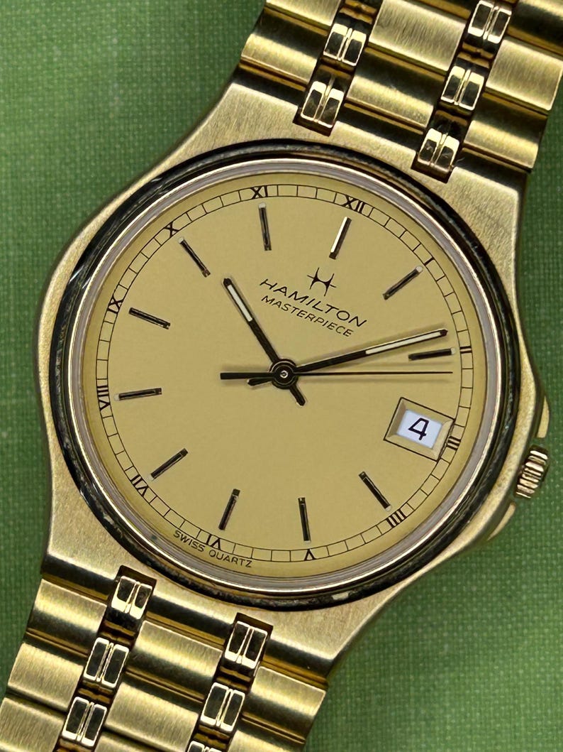 Hamilton Masterpiece Quartz watch model 9162a with gold plated case and original bracelet. Date window.  Running, keeping time, fresh battery.