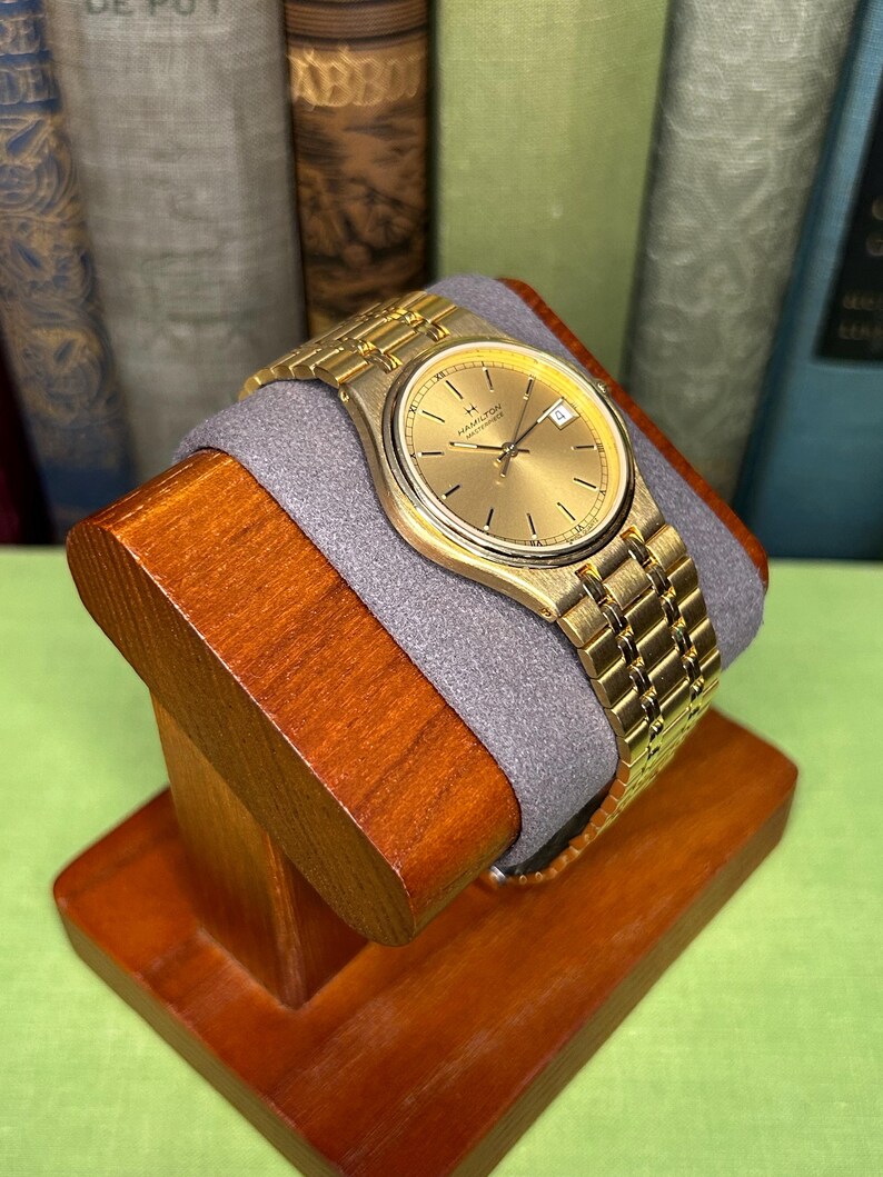 Hamilton Masterpiece Quartz watch model 9162a with gold plated case and original bracelet. Date window.  Running, keeping time, fresh battery.