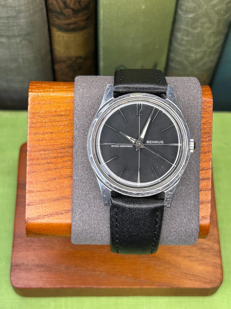 Vintage Benrus watch with black dial and stainless steel case.  Silver crown. New black leather band. Running, serviced, keeps time, working