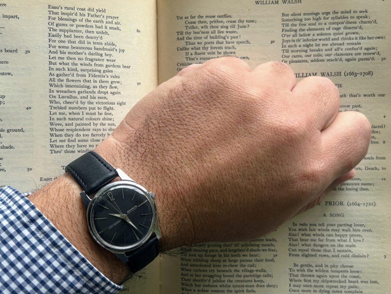 Vintage Benrus watch with black dial and stainless steel case.  Silver crown. New black leather band. Running, serviced, keeps time, working