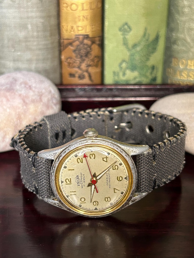 Vintage 1950s Enicar swiss watch with aluminum plated case and red sweep seconds dial. New grey canvas band. Running, serviced, keeps time, working.