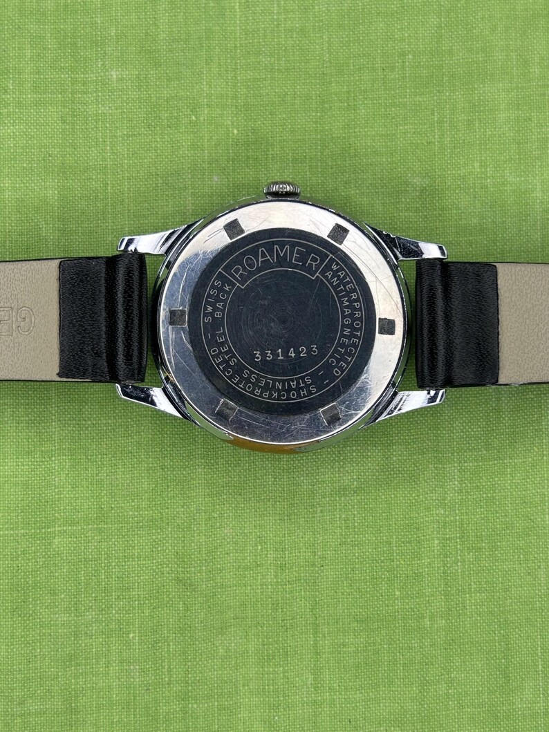 Vintage Roamer Popular watch.  black leather band.  Running, serviced working, keeping time.    Silver color case.