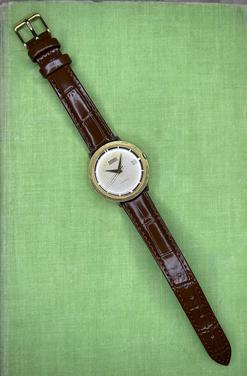 Vintage Vulcain Centenary automatic watch with gold plated case and brown leather strap.  Serviced and running.  Keeps time. working