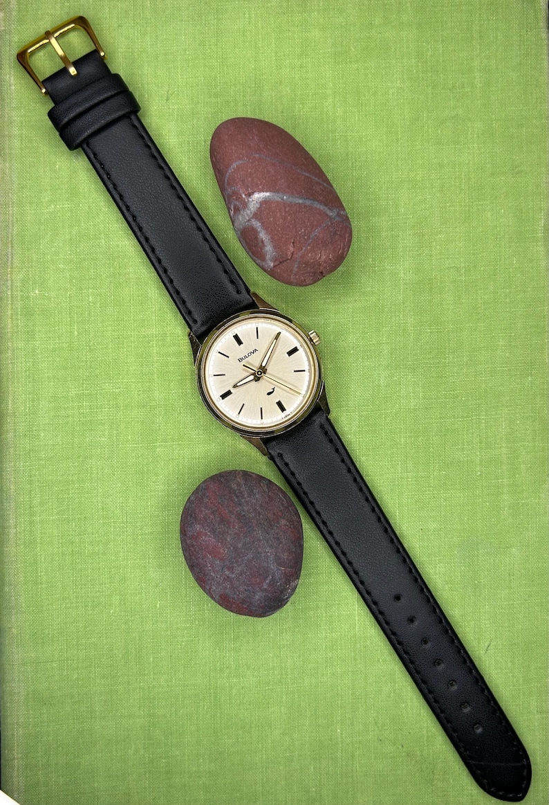 Vintage 1970 Bulova Sea King swiss watch with gold plated case and sweep seconds dial. New black leather band. Running, serviced, keeps time, working.