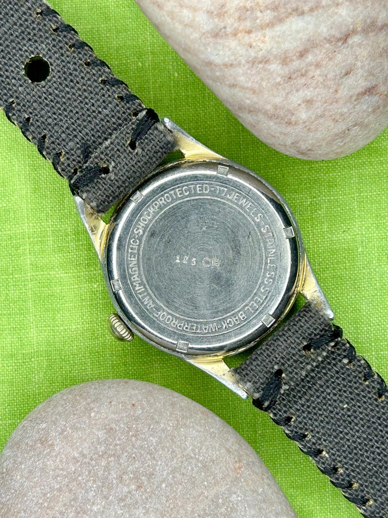 Vintage 1950s Enicar swiss watch with aluminum plated case and red sweep seconds dial. New grey canvas band. Running, serviced, keeps time, working.
