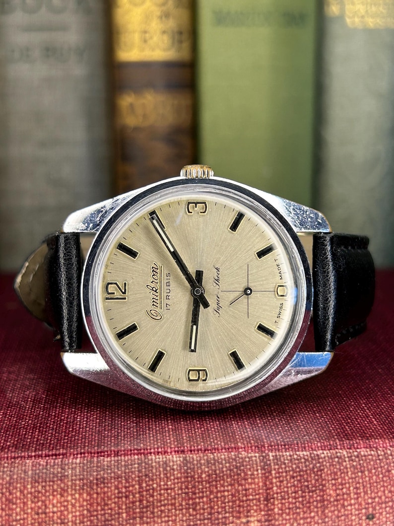 Vintage watch Omikron swiss watch with silver case and small seconds dial.  black leather band and silver crown. Running, serviced, keeps time, working.